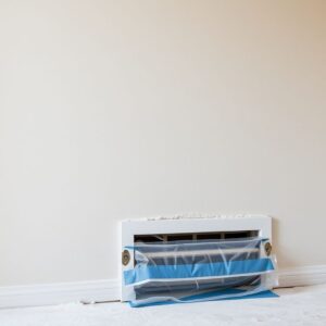 Duct cleaning after renovation Renovation drywall dust with a floor vent covered in plastic