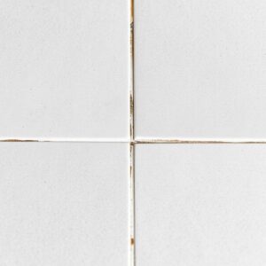 How to keep grout clean Clean white grout next to dark dirty grout on porcelain kitchen tile